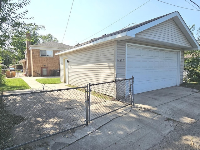 detached garage featuring a gate and fence