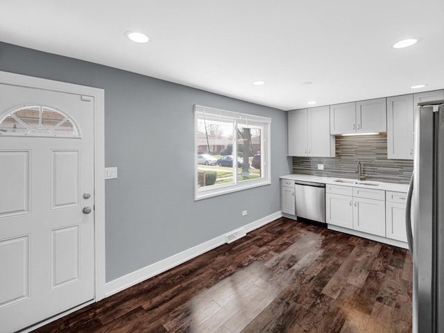 kitchen featuring a sink, light countertops, baseboards, appliances with stainless steel finishes, and visible vents