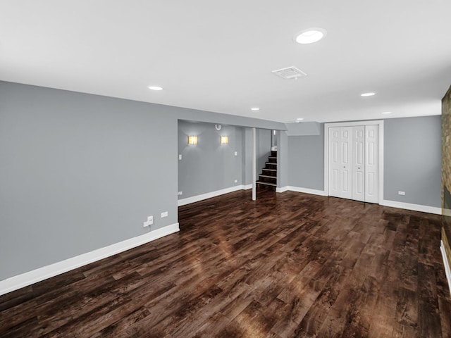 finished basement featuring baseboards, wood finished floors, recessed lighting, and stairs
