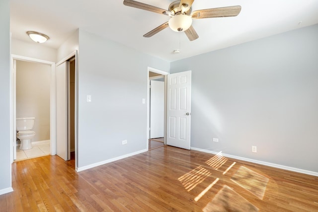 4130 192nd Ct Unit 222, Country Club Hills, IL 60478 - unfurnished bedroom with light wood-style flooring, baseboards, a ceiling fan, and ensuite bath
