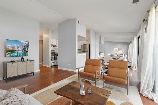 4130 192nd Ct Unit 222, Country Club Hills, IL 60478 - living room with visible vents, baseboards, wood finished floors, and lofted ceiling
