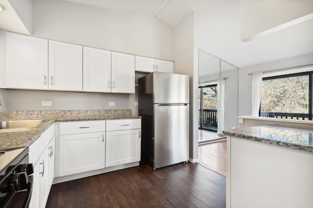 4130 192nd Ct Unit 222, Country Club Hills, IL 60478 - kitchen featuring gas stove, freestanding refrigerator, white cabinets, and dark wood-style flooring