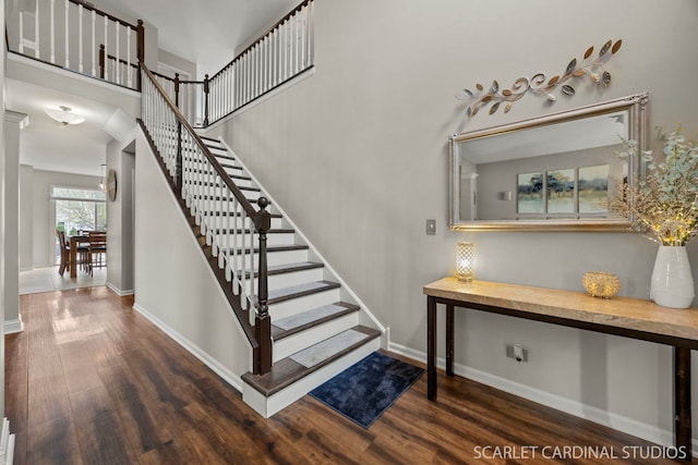 stairs with wood finished floors and baseboards