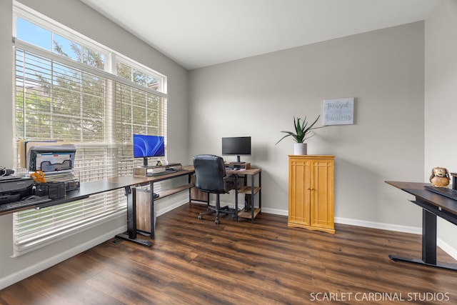 home office with dark wood-style floors and baseboards