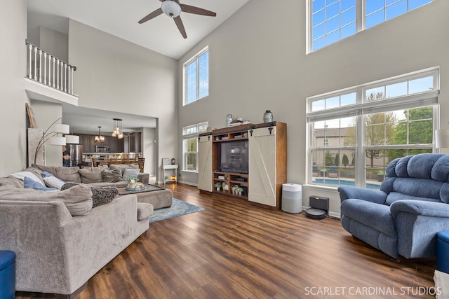 living room with high vaulted ceiling, ceiling fan, and wood finished floors