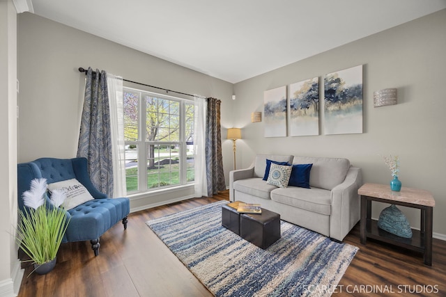 living area with wood finished floors and baseboards