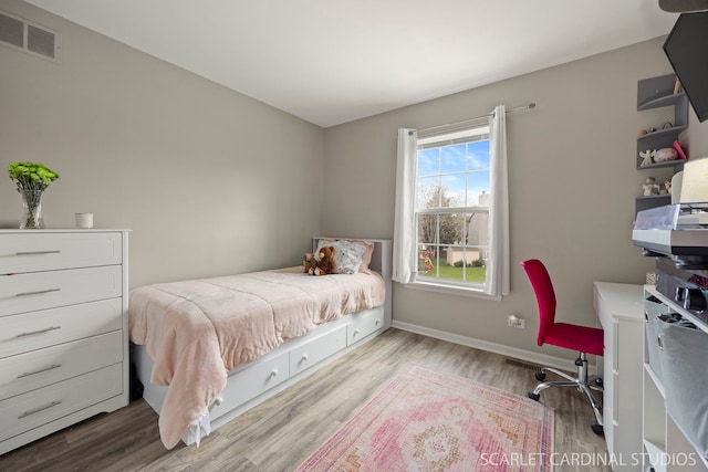 bedroom featuring wood finished floors and baseboards