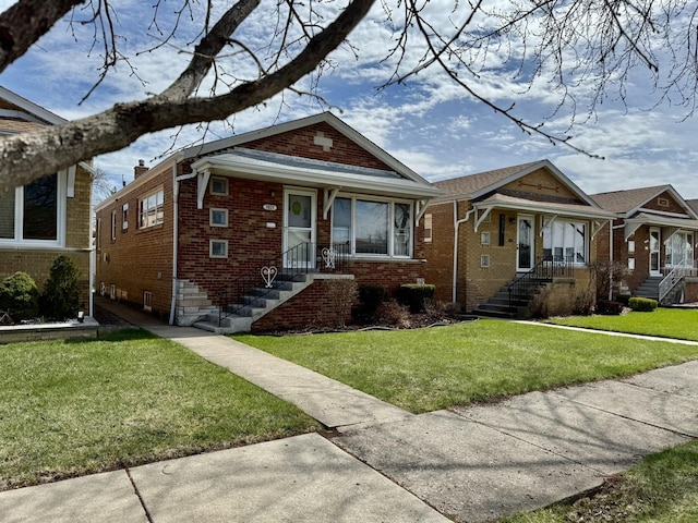 bungalow featuring a front yard and brick siding