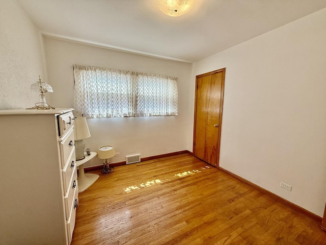 interior space featuring visible vents, baseboards, and light wood-style floors
