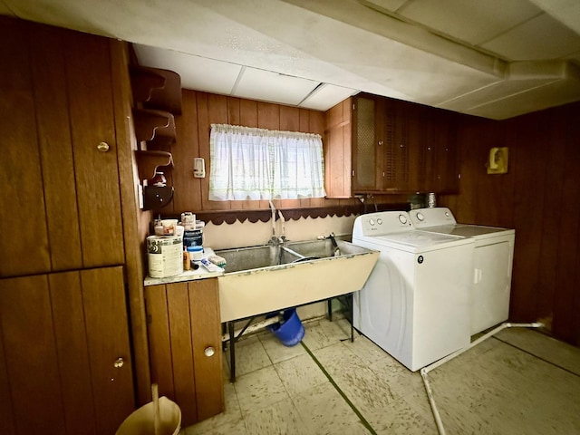 laundry area featuring washer / clothes dryer, wooden walls, laundry area, and light floors