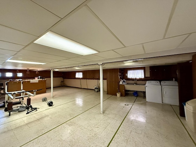 basement featuring a sink, tile patterned floors, and independent washer and dryer