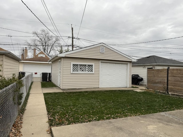 detached garage featuring cooling unit and fence