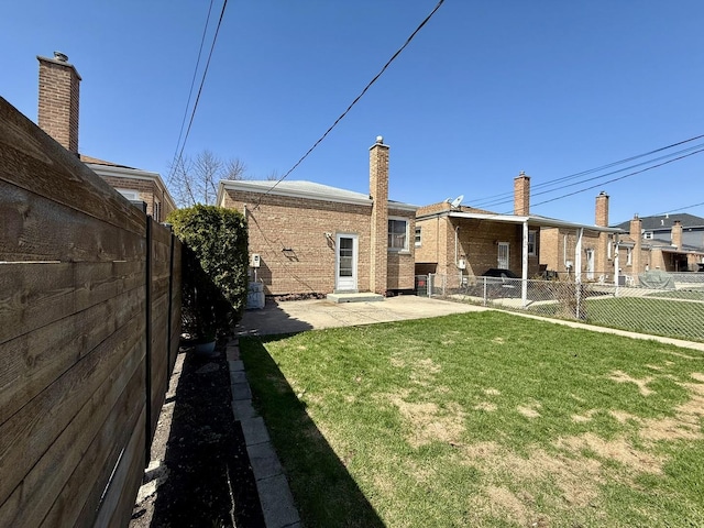 view of yard featuring a patio and a fenced backyard