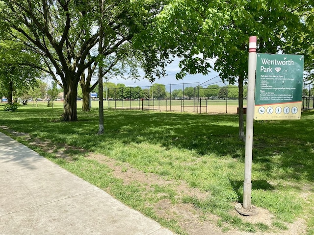 exterior space with fence and a lawn