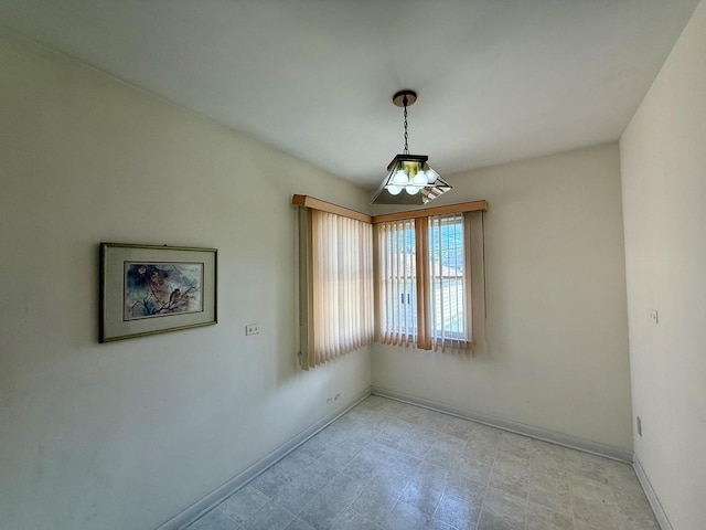 spare room featuring baseboards