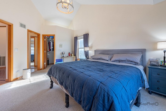 bedroom with visible vents, a spacious closet, a notable chandelier, and carpet floors