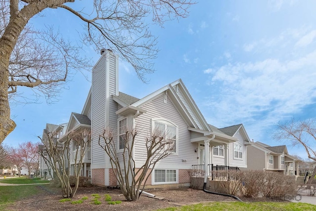 view of home's exterior with a residential view and a chimney