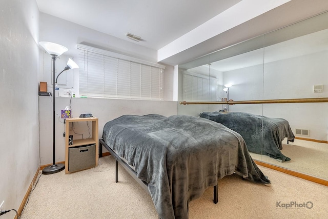 bedroom with carpet flooring, visible vents, and baseboards