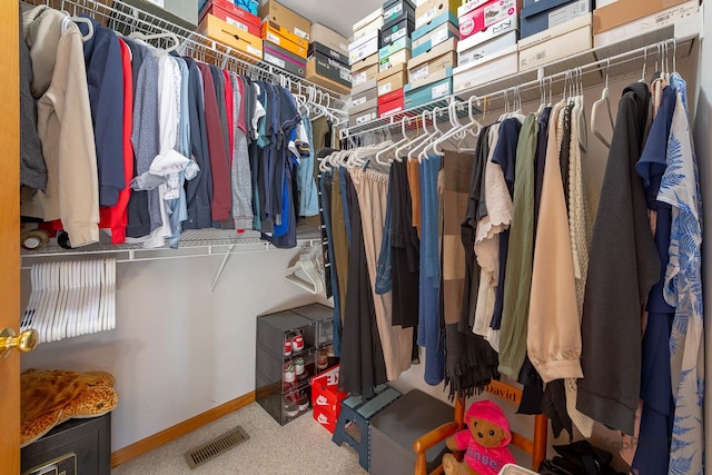 spacious closet featuring visible vents and carpet floors