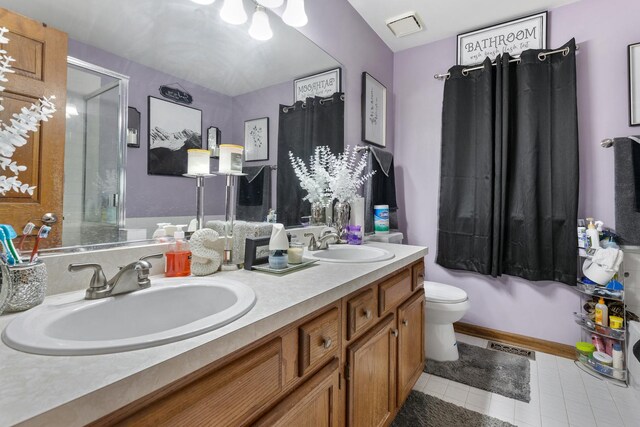 bathroom with an enclosed shower, toilet, a sink, and tile patterned flooring