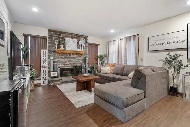 living area with recessed lighting, wood finished floors, and a fireplace