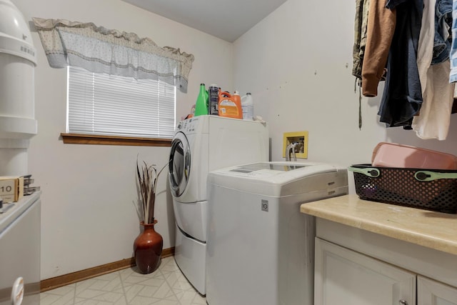 laundry area featuring washer and dryer, laundry area, and baseboards