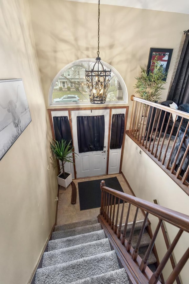 interior space featuring baseboards and an inviting chandelier