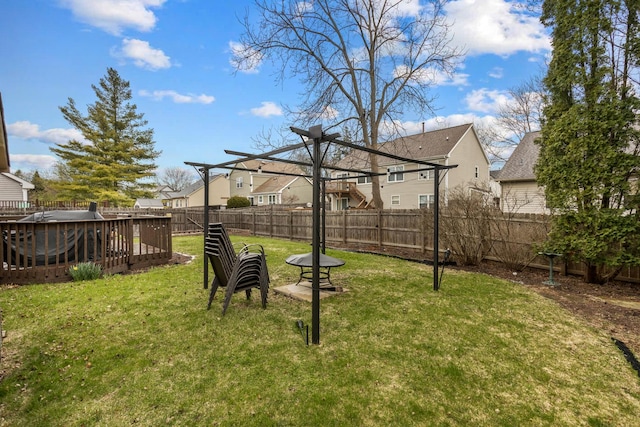 view of yard with a fenced backyard, a residential view, and a deck