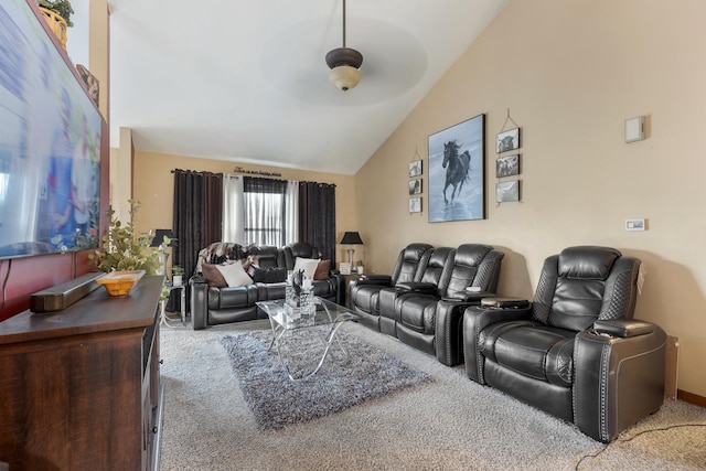 living room featuring a ceiling fan, vaulted ceiling, and carpet