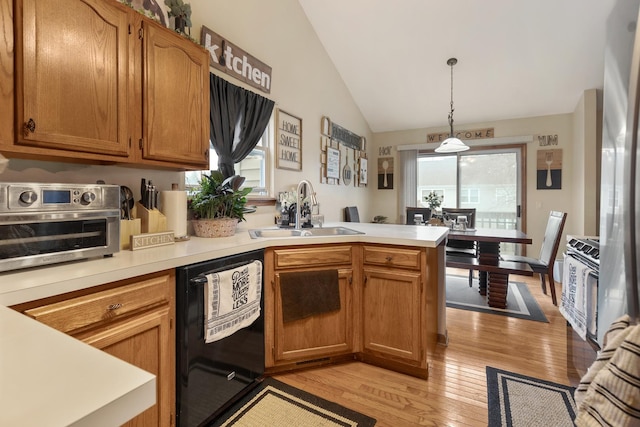 kitchen with a sink, dishwasher, light countertops, a peninsula, and lofted ceiling