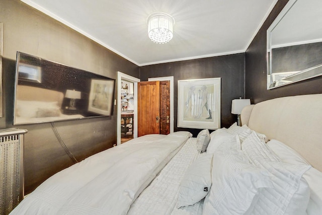 bedroom featuring crown molding and a chandelier