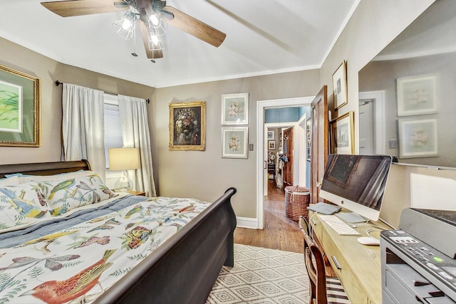 bedroom with ornamental molding, light wood-style flooring, ceiling fan, and baseboards