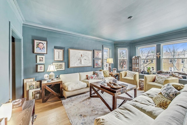 living room with ornamental molding and light wood finished floors