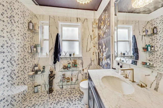 full bathroom with toilet, vanity, a notable chandelier, and ornamental molding