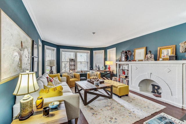 living area with crown molding and wood finished floors