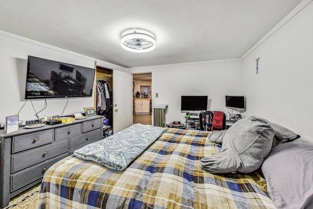 bedroom featuring a closet and crown molding