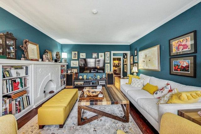 living room with ornamental molding and wood finished floors