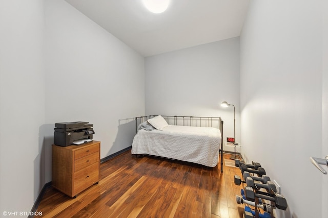 bedroom featuring baseboards and hardwood / wood-style floors