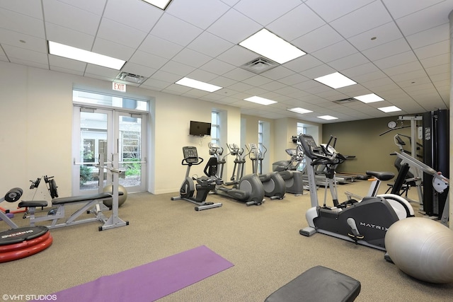 gym with french doors, visible vents, a drop ceiling, and carpet floors