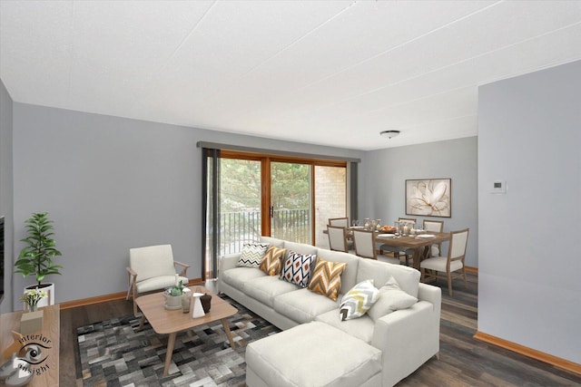 living area featuring baseboards and wood finished floors