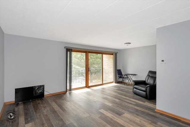 living room featuring wood finished floors and baseboards