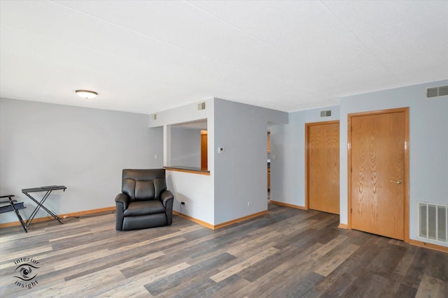 interior space with a wealth of natural light, baseboards, and wood finished floors