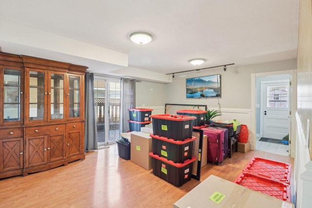 playroom featuring wainscoting and wood finished floors