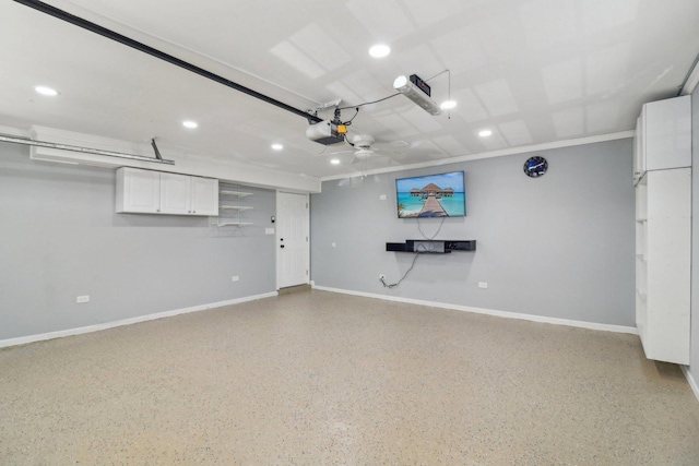 garage with a garage door opener, baseboards, and recessed lighting