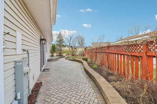 view of side of home with a patio and a fenced backyard
