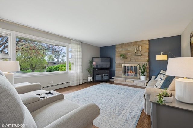 1112 N Perry Dr, Palatine, IL 60067 - living area featuring a baseboard heating unit, a stone fireplace, and wood finished floors