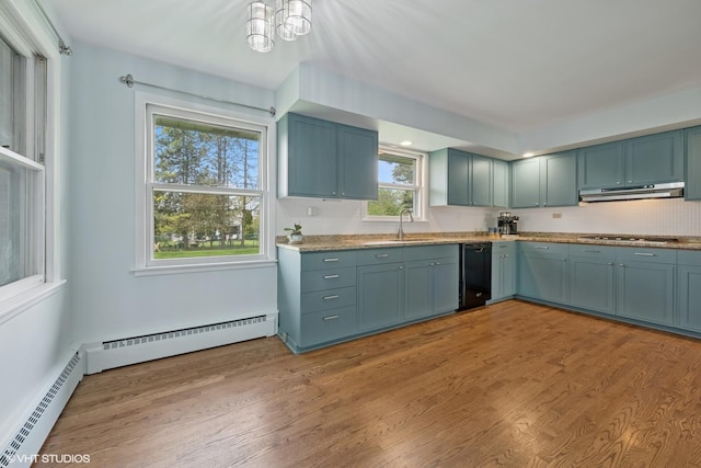 1112 N Perry Dr, Palatine, IL 60067 - kitchen with black dishwasher, under cabinet range hood, a baseboard radiator, light wood-style floors, and stovetop