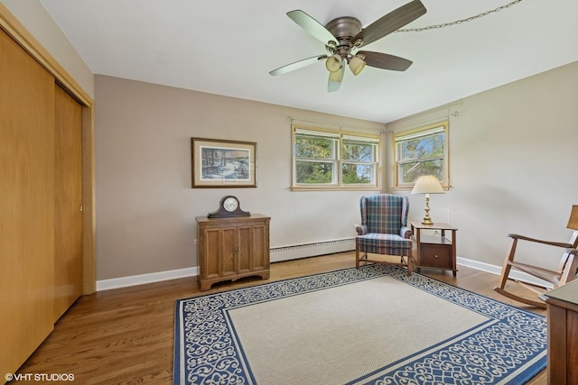 1112 N Perry Dr, Palatine, IL 60067 - living area with baseboard heating, wood finished floors, a ceiling fan, and baseboards