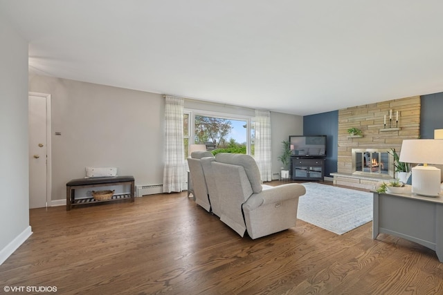 1112 N Perry Dr, Palatine, IL 60067 - living room with baseboard heating, wood finished floors, a stone fireplace, and baseboards