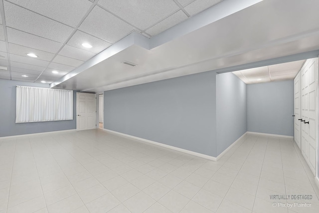finished below grade area featuring recessed lighting, visible vents, baseboards, and a paneled ceiling